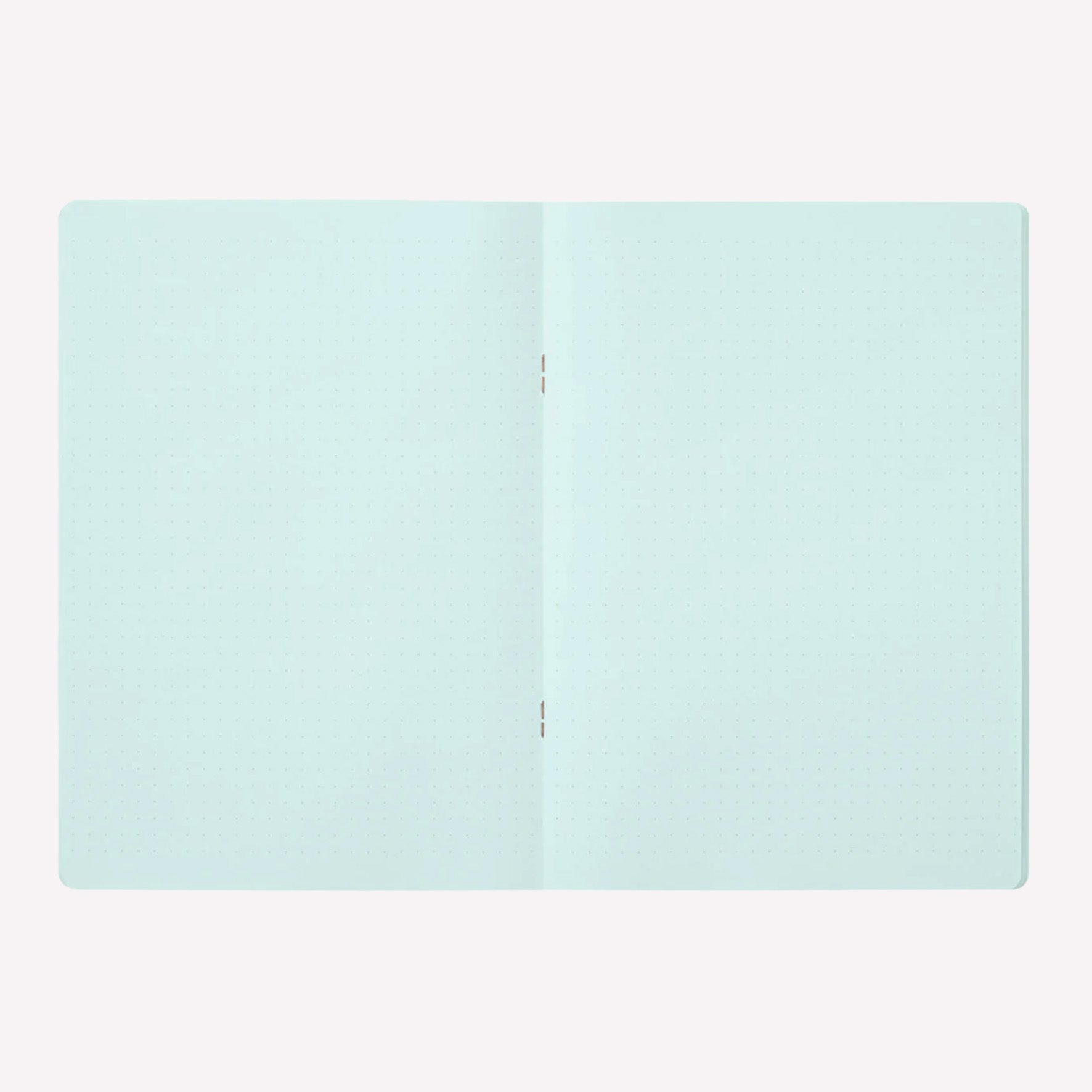 Inside the Midori soft cover stapled notebook. Dot grid pages are a pale blue with a 5mm spacing. 