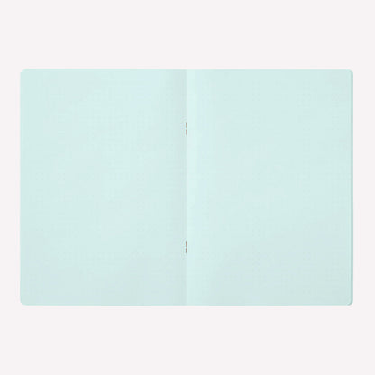 Inside the Midori soft cover stapled notebook. Dot grid pages are a pale blue with a 5mm spacing. 
