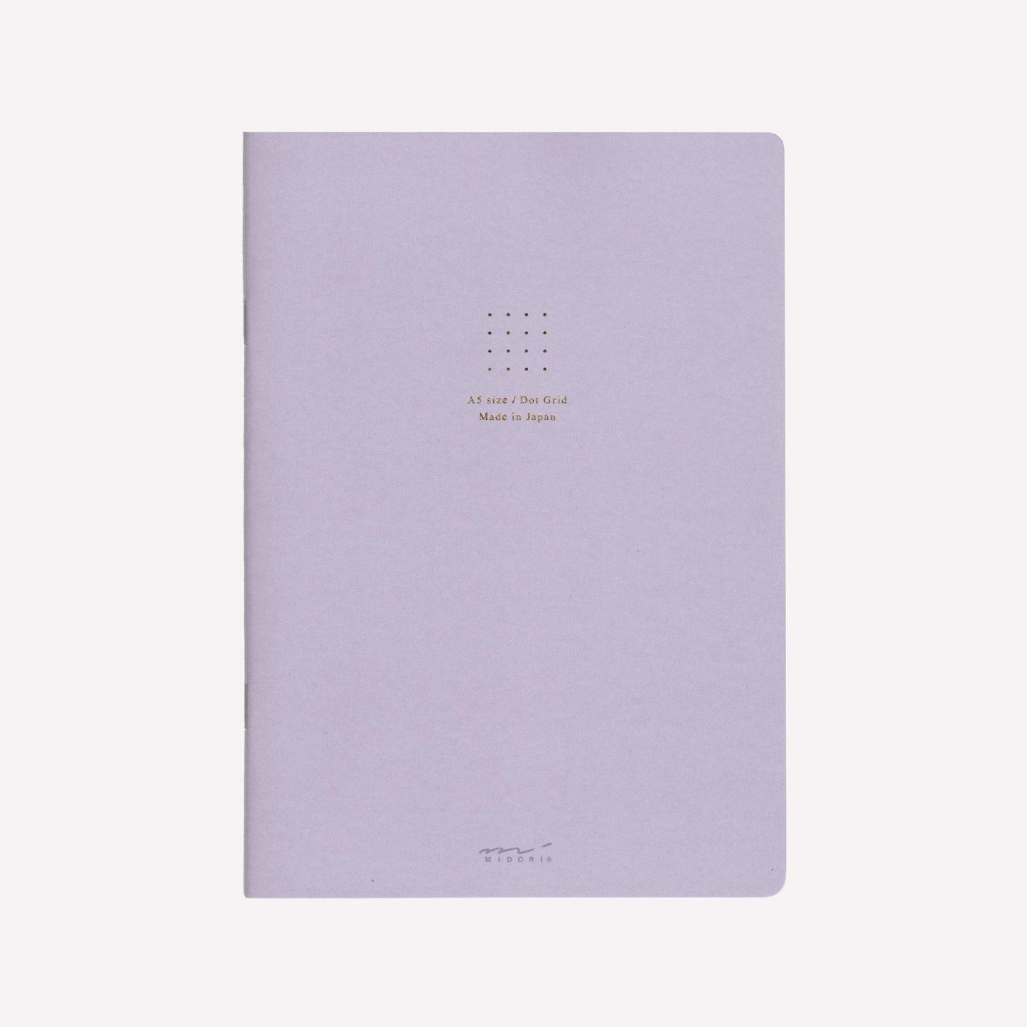 Front cover of the Midori purple soft cover sketchbook with gold foil text in the centre reading "A5 size/Dot Grid. Made in Japan". 