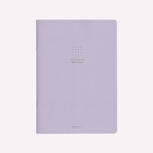 Front cover of the Midori purple soft cover sketchbook with gold foil text in the centre reading "A5 size/Dot Grid. Made in Japan". 