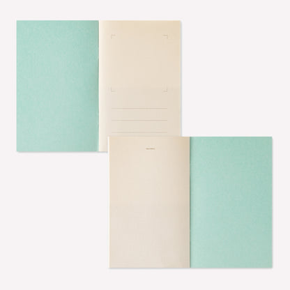 Midori peelable sticker book with a yellow cover displayed open to show the sticker release paper inside. 