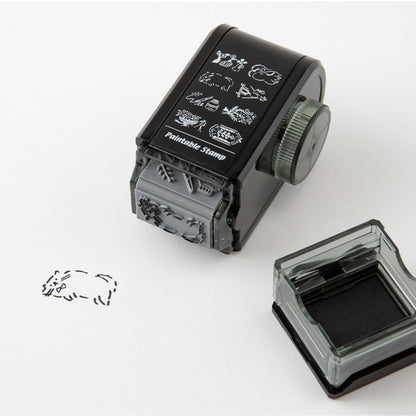 Lifestyle image of Midori's antique rotating paintable stamp in use. 