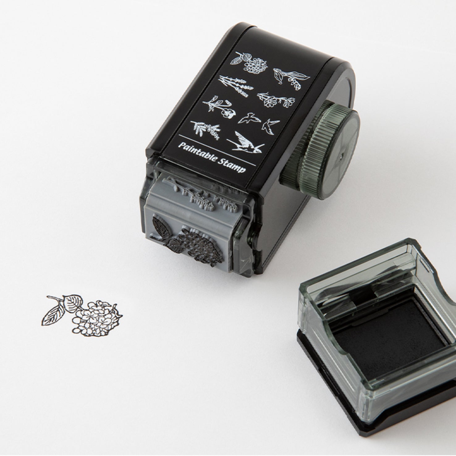 Lifestyle image of Midori's bird and flower rotating paintable stamp in use. 