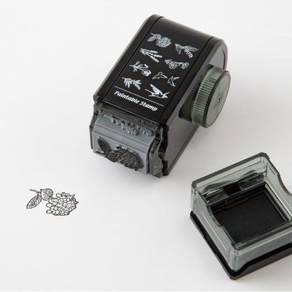 Lifestyle image of Midori's bird and flower rotating paintable stamp in use. 