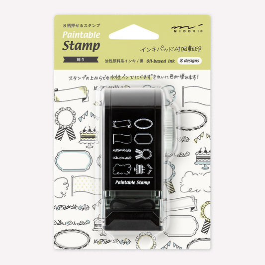 Midori paintable rotating stamp with 8 different decorative frame stamp designs  presented in packaging to show the designs. 