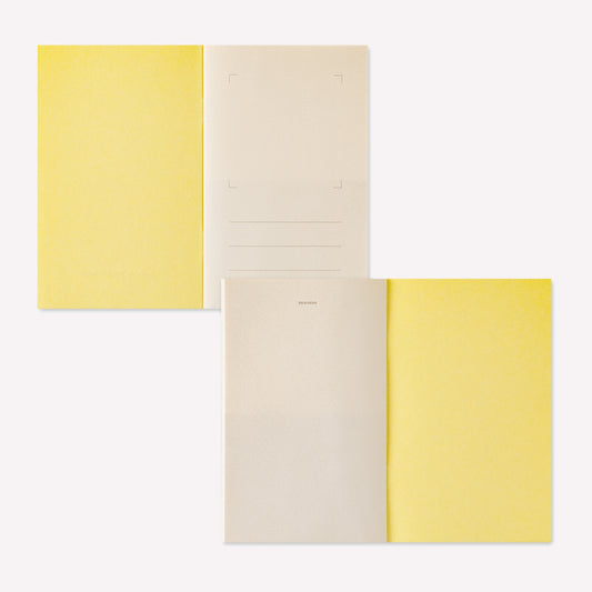 Midori peelable sticker book with a yellow cover displayed open to show the sticker release paper inside. 