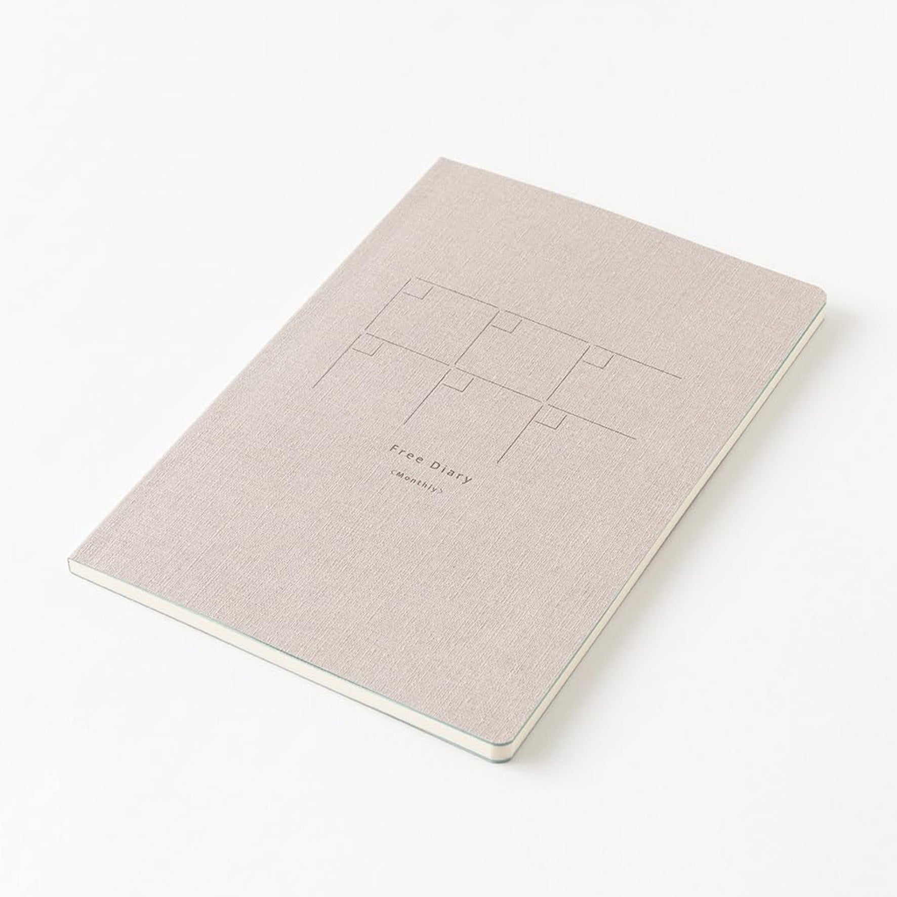 Midori Yuru Log Free Diary undated monthly planner with a beige cover lying on a white background. 