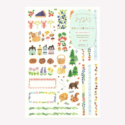 Midori Scandinavian Forest Yuru Log decorative sticker sheet with designs including forest animals, berries, houses, pastries and decorative borders, packaged in a protective plastic sleeve. 