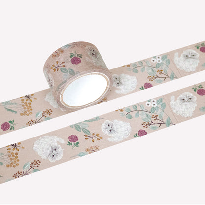 Miyuki Matsuo open roll and swatch of masking tape with floral and cat design on a on a peach background. 