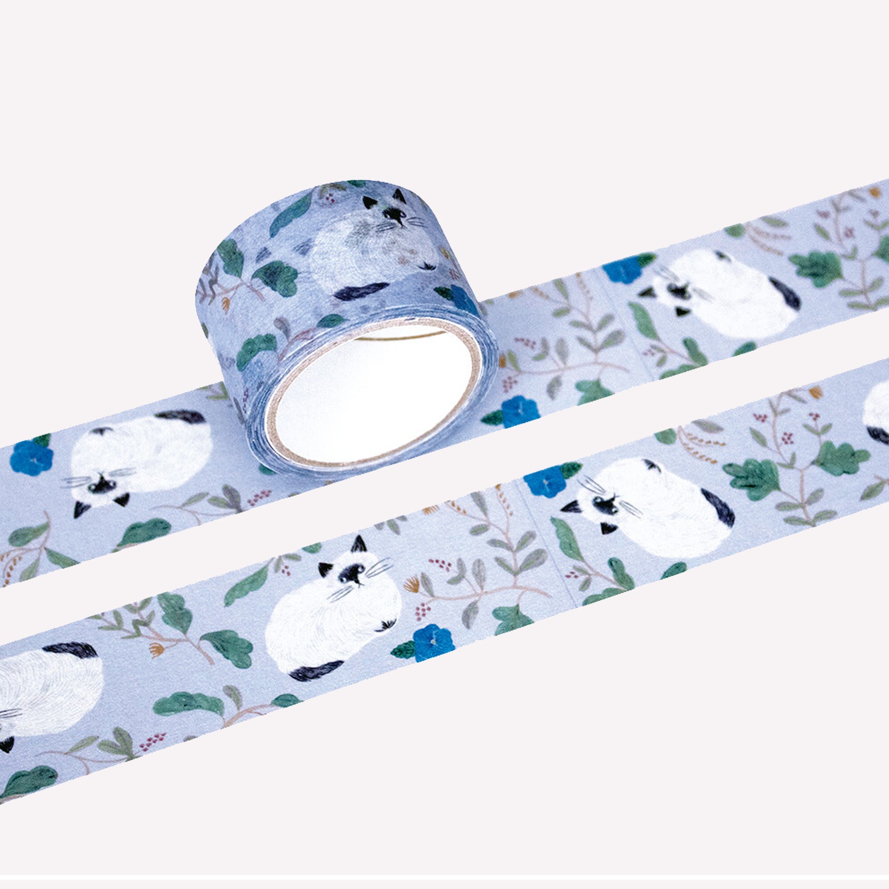 Miyuki Matsuo roll and swatch of masking tape with floral and "Repos" cat design on a on a purple background. 