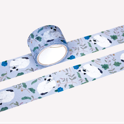 Miyuki Matsuo roll and swatch of masking tape with floral and "Repos" cat design on a on a purple background. 