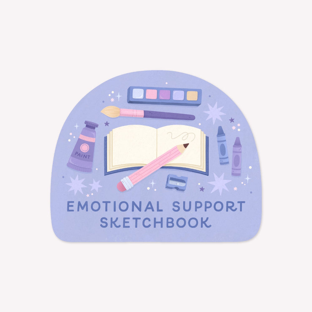 Illustrated sticker featuring a sketchbook, pencil and other art supplies on a purple background, with text below that reads "Emotional Support Sketchbook".