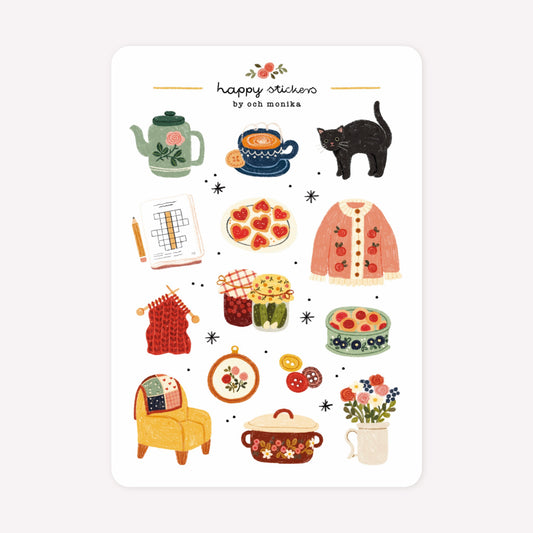 Cosy granny themed sticker sheet by Och Monika, with hand-drawn designs including a black cat, cups of tea, cross-stitch and knitting projects and crosswords.