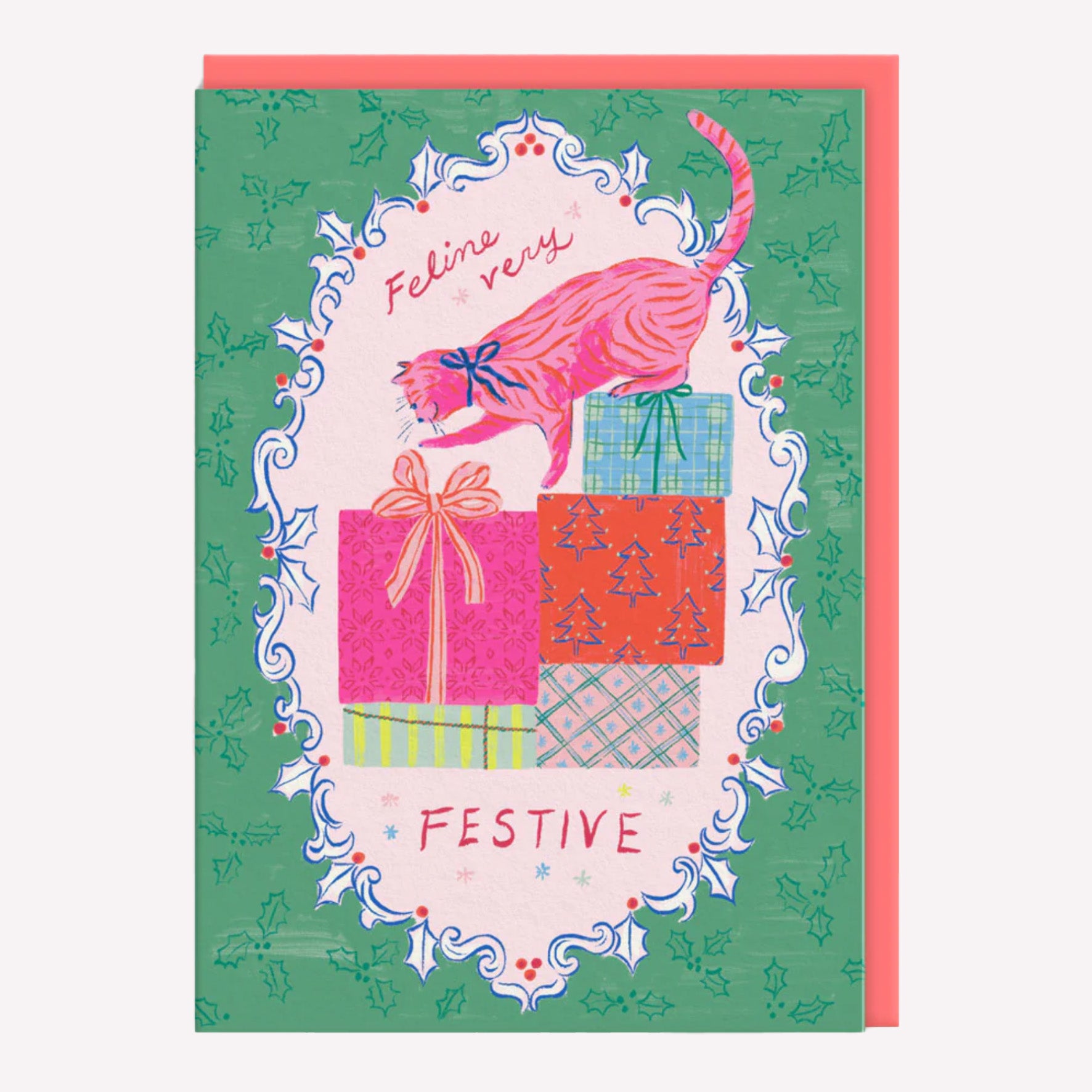 Christmas greetings card featuring an illustrated cat and presents on a green background with a poppy red envelope. Text reads "feline very festive."