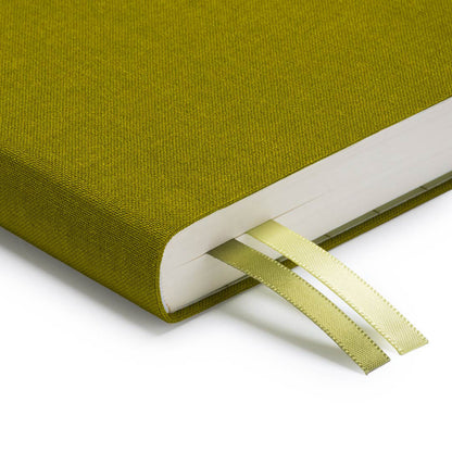 A close up of the corner of Ohh Deer's olive green daily planner, showing the quality of the linen-style fabric and the two divider ribbons.