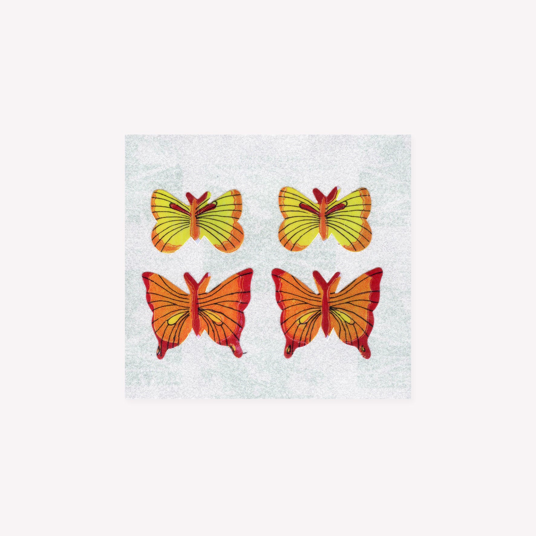 Four pearlie, shiny yellow butterfly stickers on a mini sticker sheet from Stickermagic.