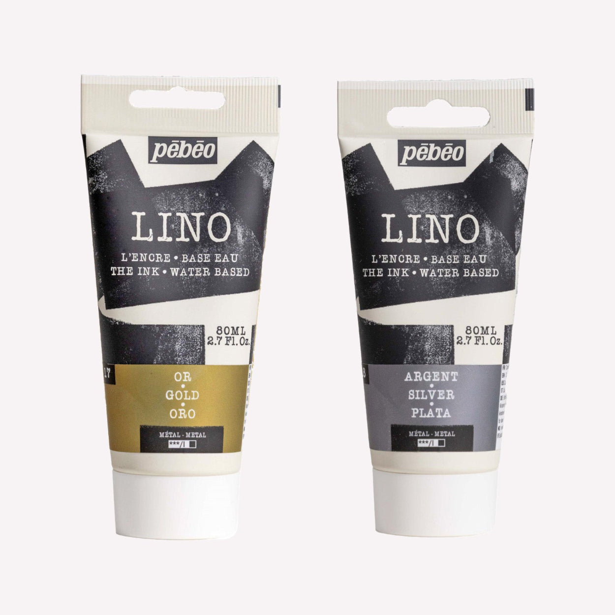 Two tubes of Pebeo water-based printmaking lino ink in metallic gold and metallic silver, shown on a white background.
