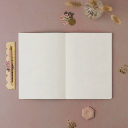 An open plain paper notebook by Sister Paper Co.