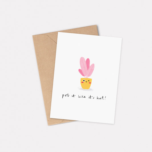 An A6 illustrated card, featuring a pink plant in a yellow pot with a cheeky face. The text below the illustration reads 'Pot it like it's hot!'. The card has a kraft brown envelope beneath it. 