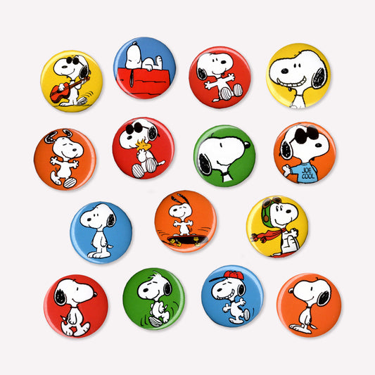 Fifteen individual button badges featuring Snoopy doing various activities like riding a skateboard, playing guitar and lying on his kennel roof. 