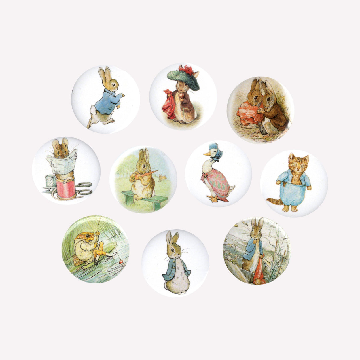 Ten individual button pin badges with various Beatrix Potter designs, including Peter Rabbit, Tom Kitten, Jemima Puddle-Duck and Jeremy Fisher.