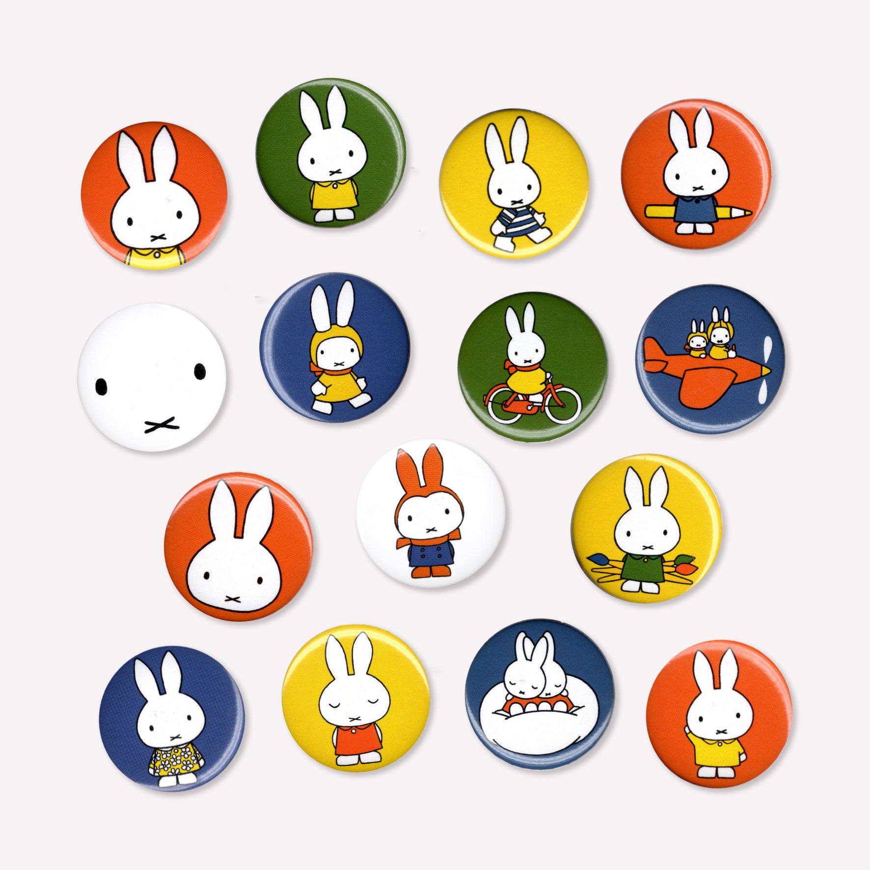 Fifteen individual button pin badges with various Miffy cartoon designs, including Miffy with art supplies, riding a bike, flying a plane and snugging in bed. 