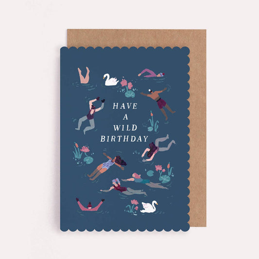 Illustrated scallop edge greetings card with a design of people swimming on a dark blue background and text reading "Have a Wild Birthday". 