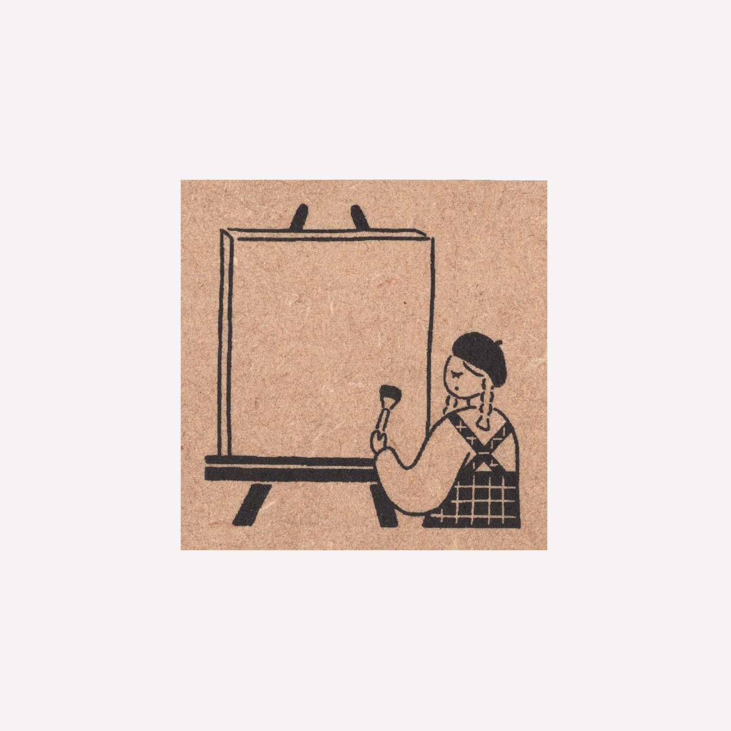 Rubber journalling stamp with a design of a girl painting at an easel frame. 