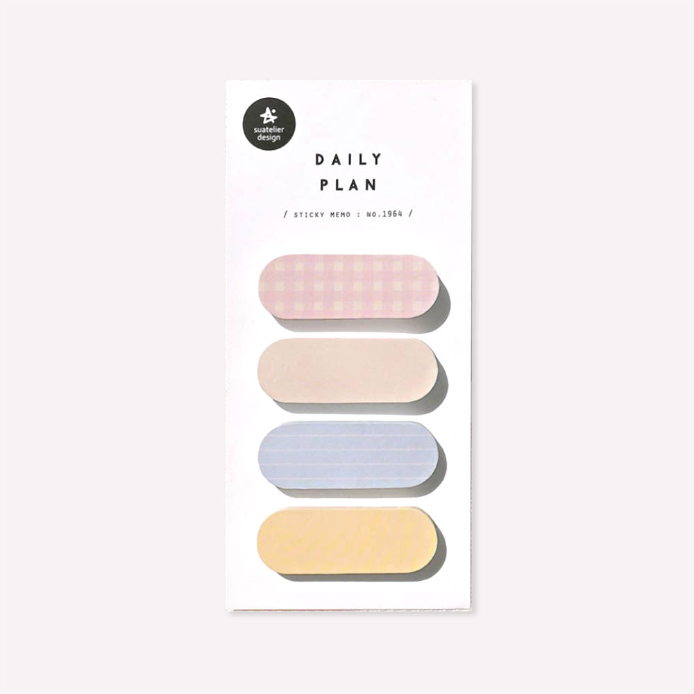 Daily plan memo notes no. 1964 by Suatelier. This pack of sticky memo notes includes four oval shaped designs, two plain in shades of yellow and two with a gingham or lined pattern in either pastel pink or pastel blue.