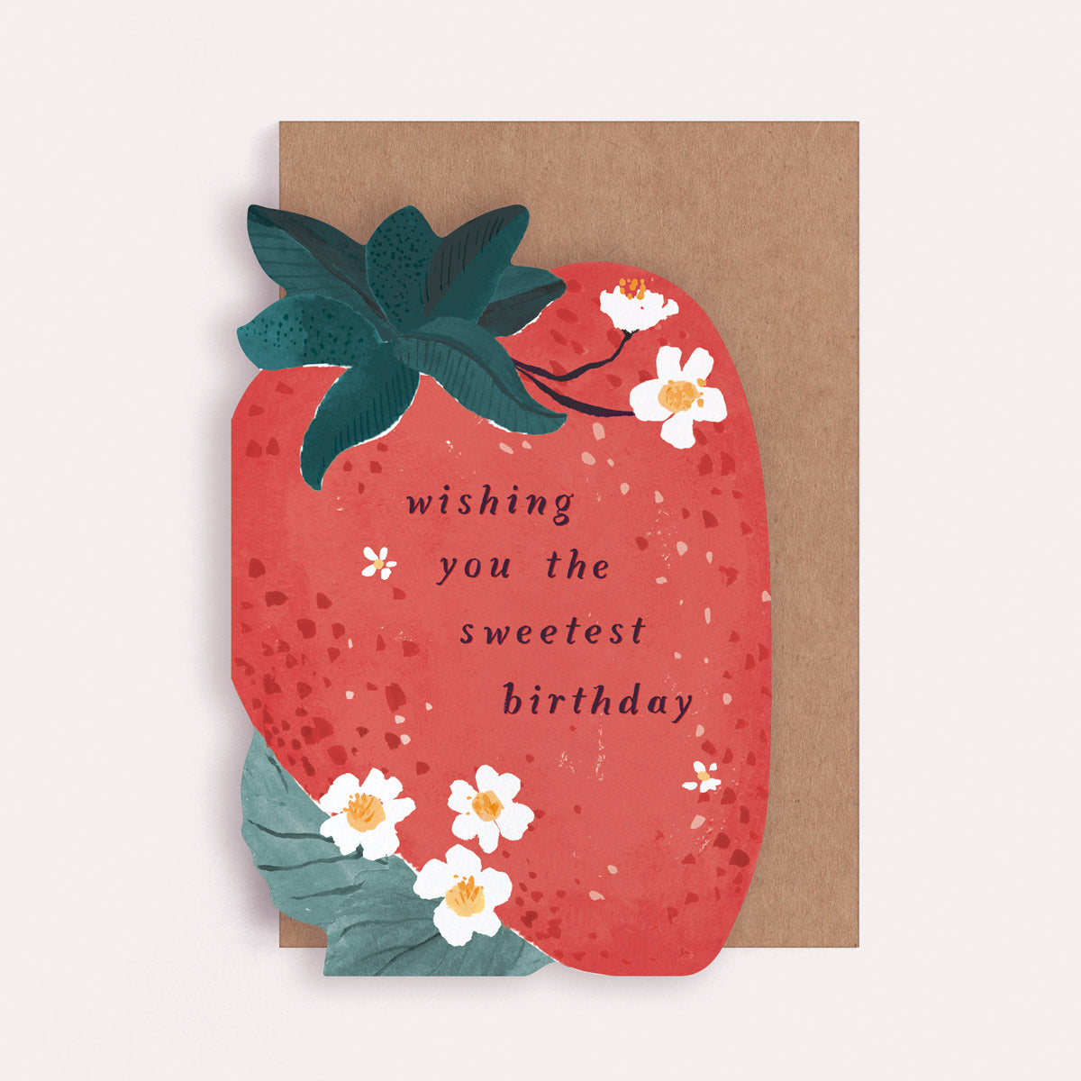 An illustrated greetings card by Sister Paper Co in the shape of a strawberry, with text that reads "Wishing You The Sweetest Birthday".