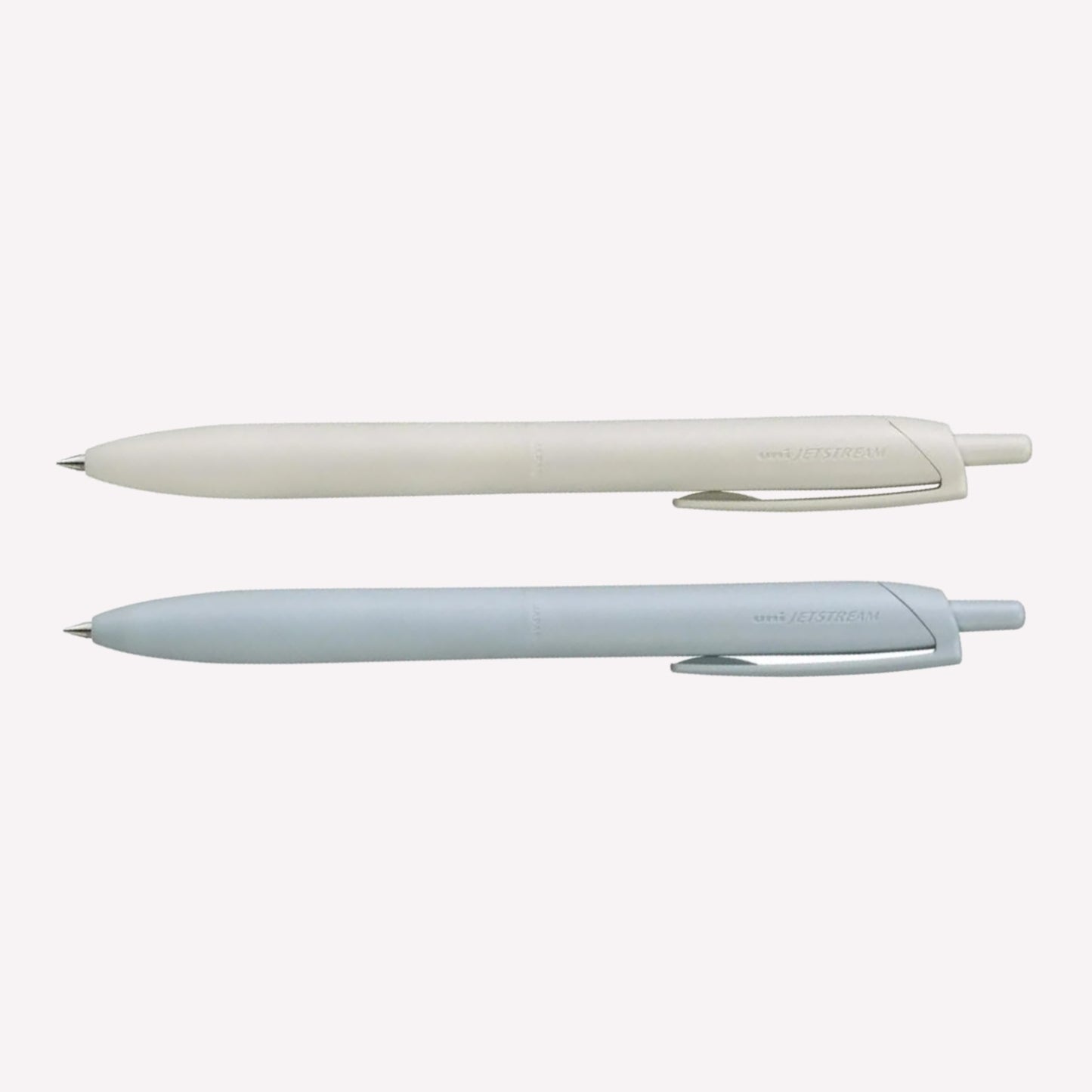 Uni Jetstream Lite Touch gel pens on a white background available in shell white and light blue. 