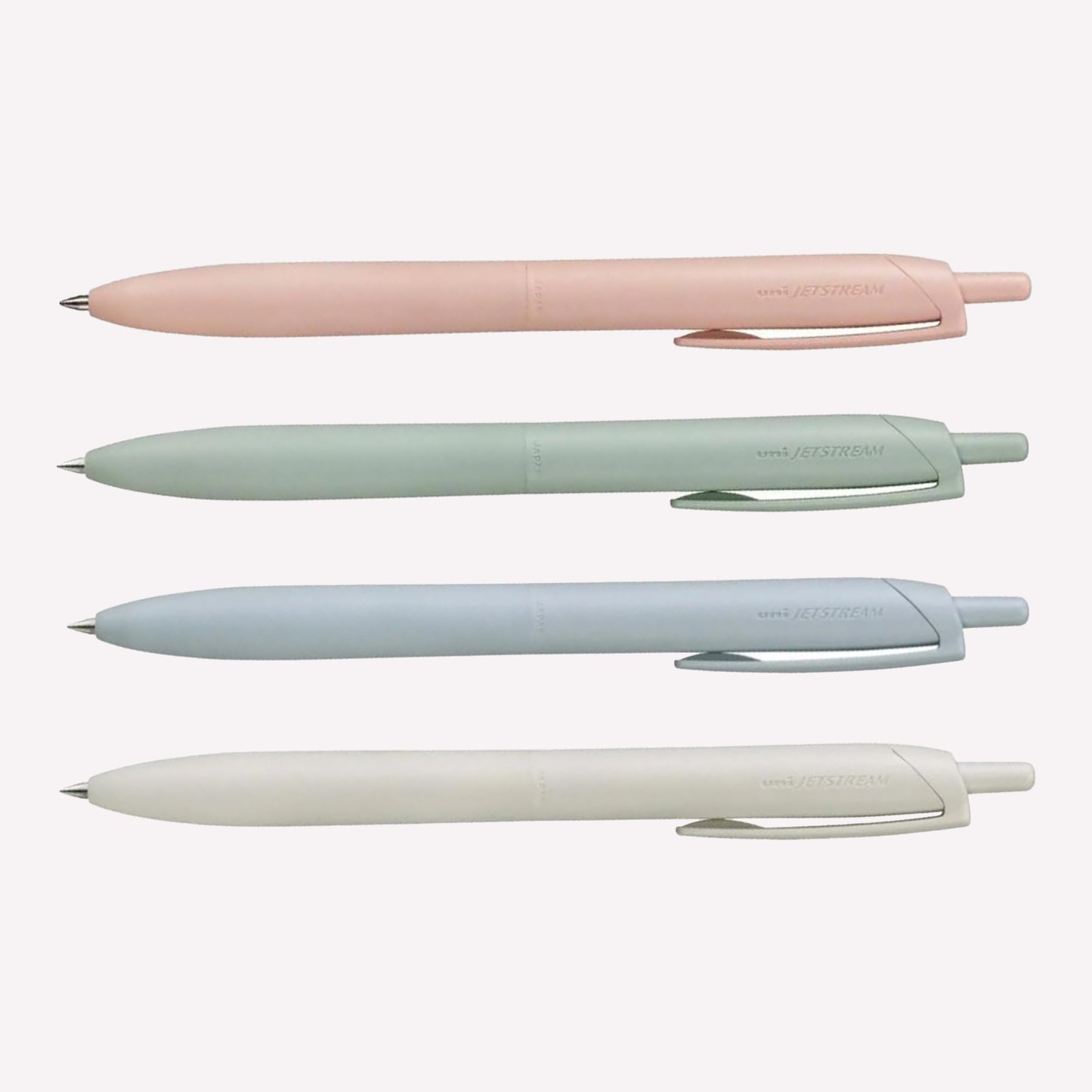 Uni Jetstream Lite Touch gel pens on a white background available in coral pink, sage green, light blue and shell white. 