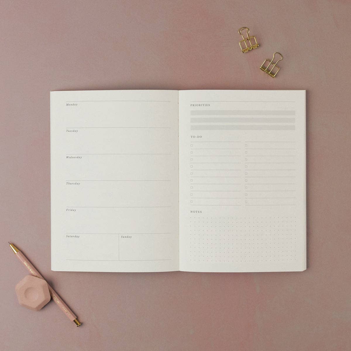 Open planner from Sister Paper Co showing the weekly page layout.
