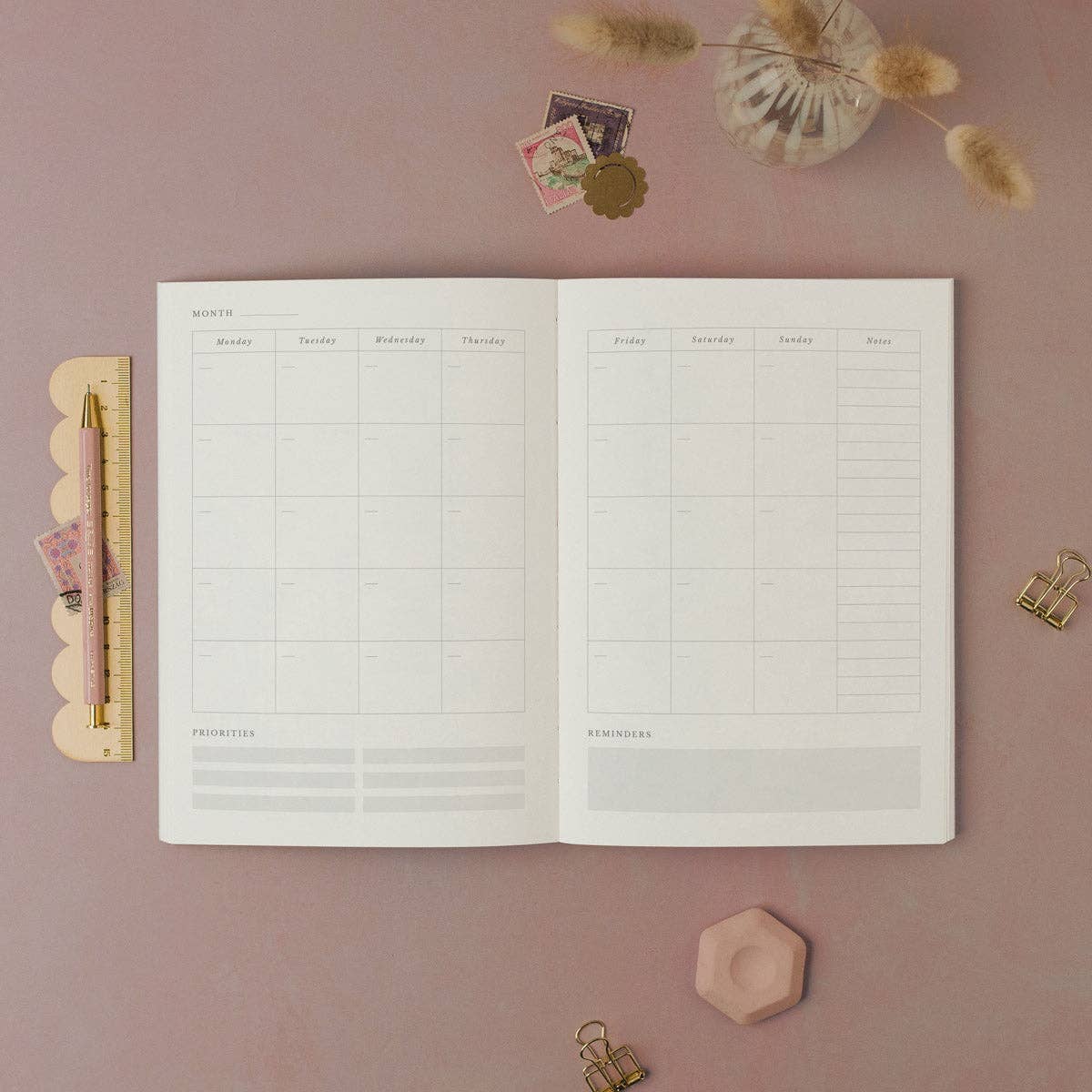Open planner from Sister Paper Co showing the monthly calendar layout.