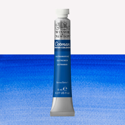 Winsor & Newton Cotman watercolour paint packaged in 8ml silver tubes with a white lid in the shade Ultramarine over a highly pigmented colour swatch.
