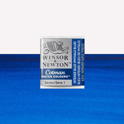 Winsor & Newton Cotman watercolour half pan in the shade Intense (Phthalo) Blue over a vibrant colour swatch. These half pans have a solid formula and are packaged in compressed paint cake. 