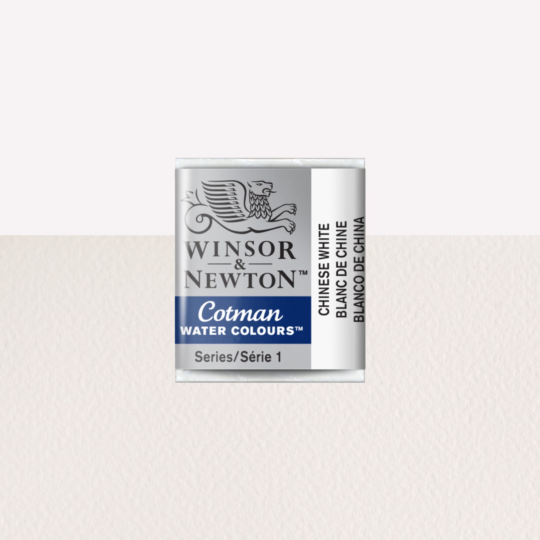 Winsor & Newton Cotman watercolour half pan in the shade Chinese White over a vibrant colour swatch. These half pans have a solid formula and are packaged in compressed paint cake. 