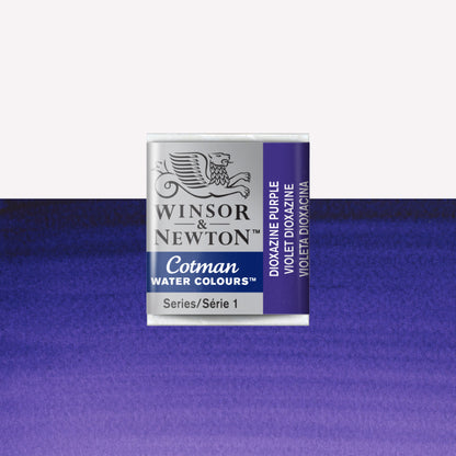 Winsor & Newton Cotman watercolour half pan in the shade Dioxazine Purple over a vibrant colour swatch. These half pans have a solid formula and are packaged in compressed paint cake. 