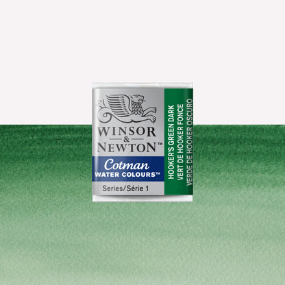Winsor & Newton Cotman watercolour half pan in the shade Hooker’s Green Dark over a vibrant colour swatch. These half pans have a solid formula and are packaged in compressed paint cake. 