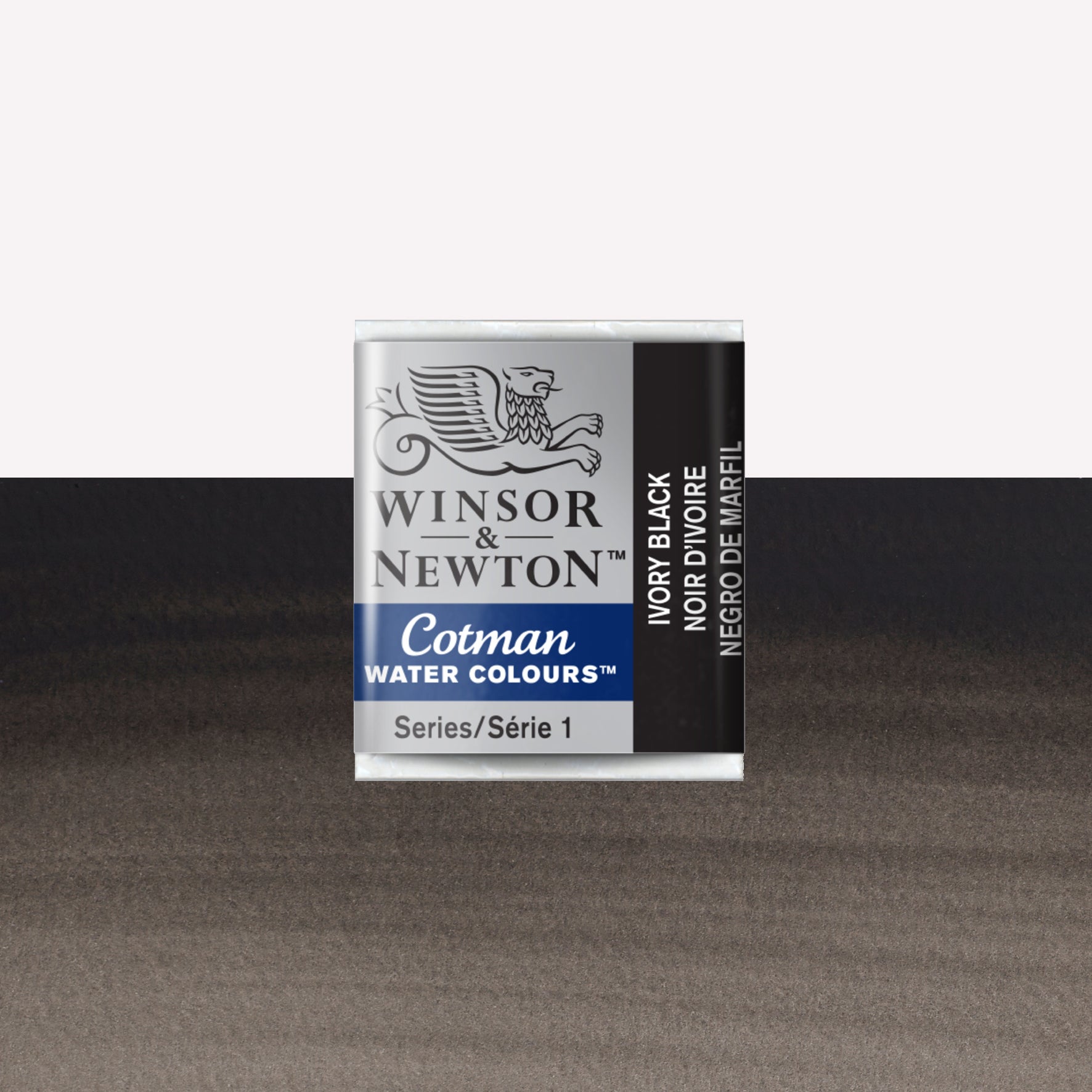 Winsor & Newton Cotman watercolour half pan in the shade Ivory Black over a vibrant colour swatch. These half pans have a solid formula and are packaged in compressed paint cake. 
