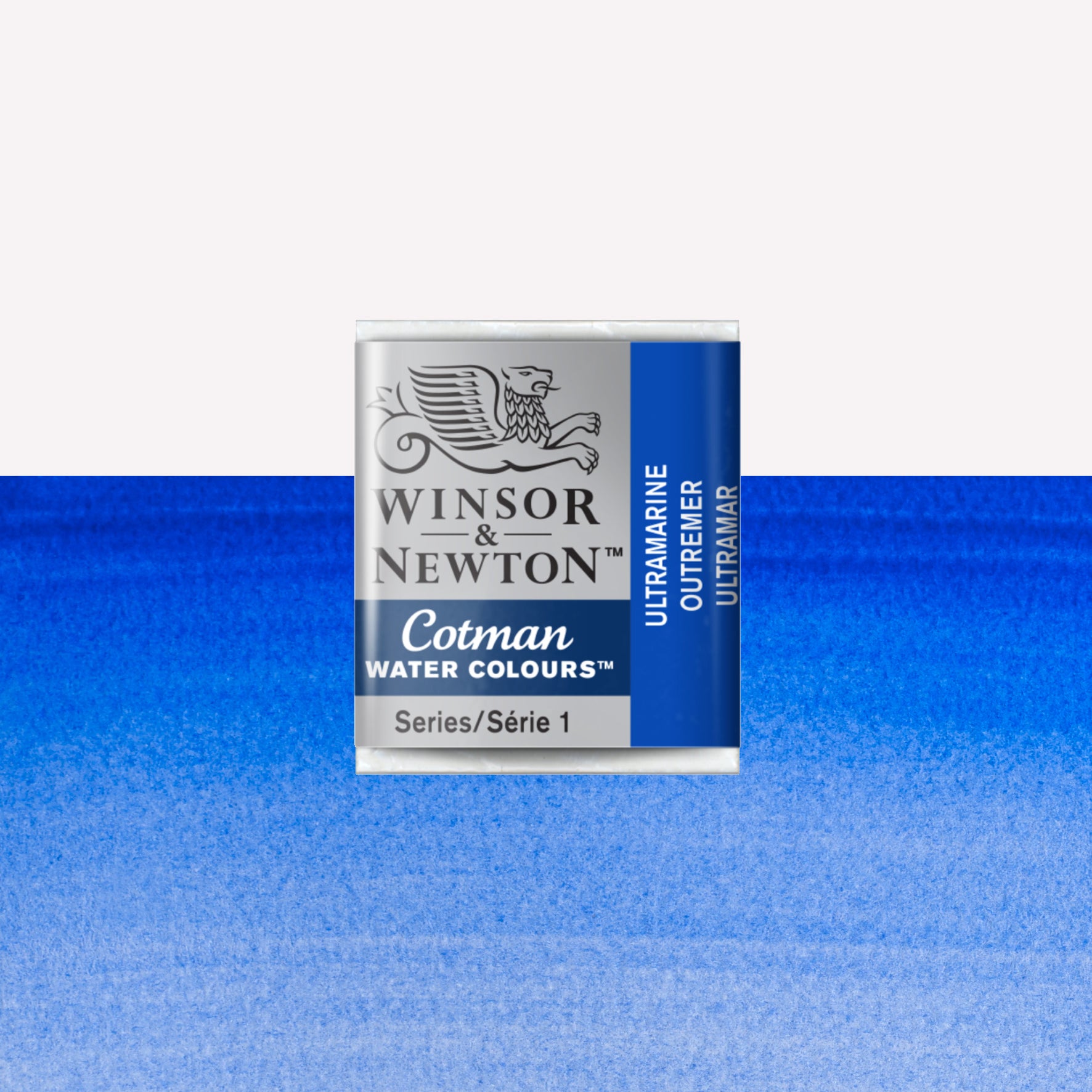 Winsor & Newton Cotman watercolour half pan in the shade Ultramarine over a vibrant colour swatch. These half pans have a solid formula and are packaged in compressed paint cake. 