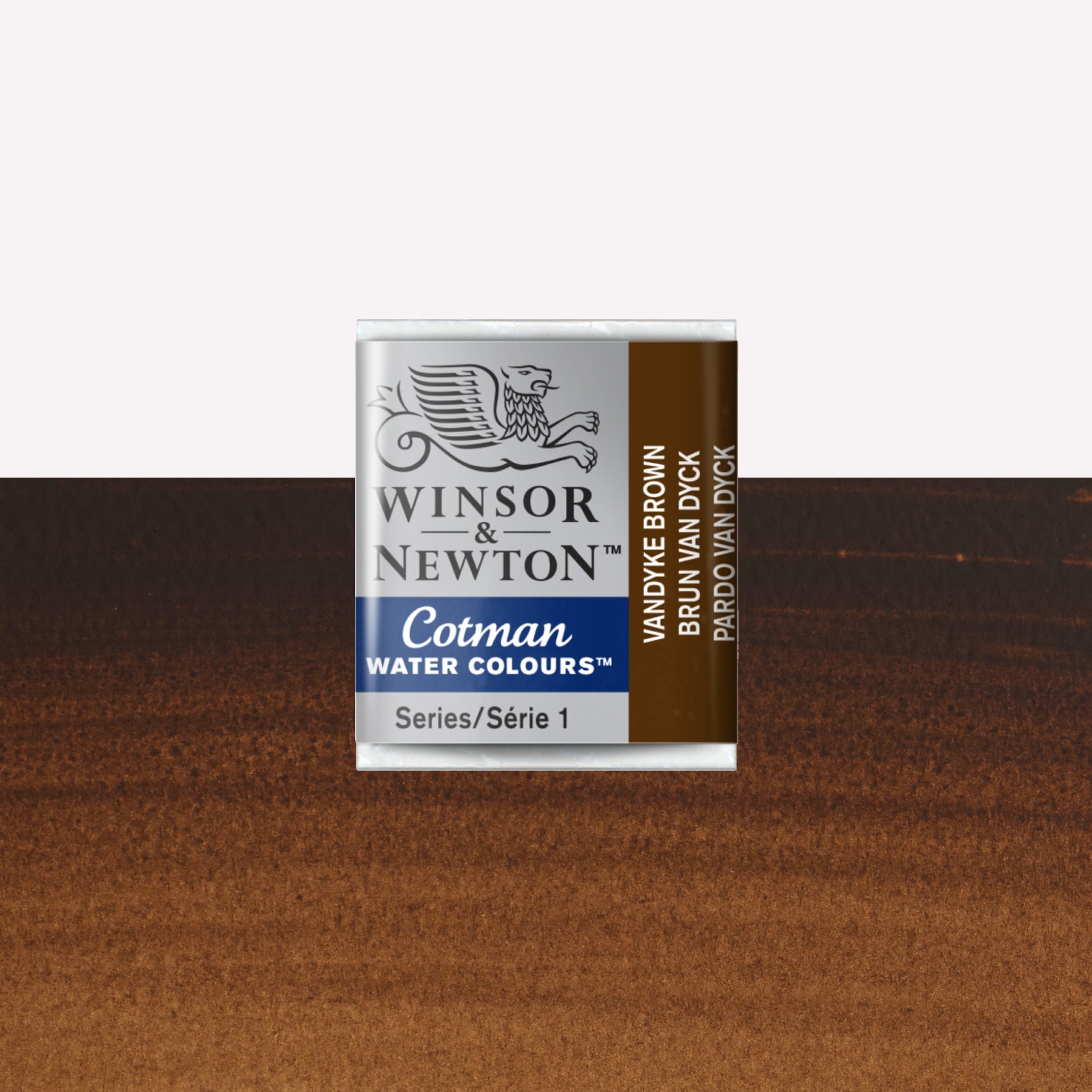 Winsor & Newton Cotman watercolour half pan in the shade Vandyke Brown over a vibrant colour swatch. These half pans have a solid formula and are packaged in compressed paint cake. 