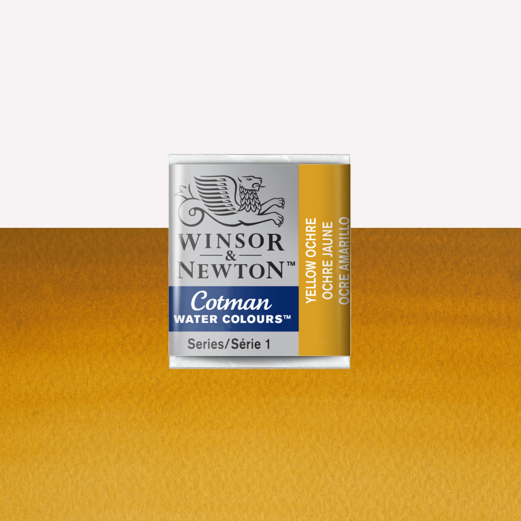 Winsor & Newton Cotman watercolour half pan in the shade Yellow Ochre over a vibrant colour swatch. These half pans have a solid formula and are packaged in compressed paint cake. 