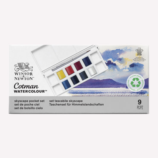 Cotman Watercolour Skyscape pocket set, presented in packaging that shows the 8 half pans included, alongside examples of a sky and seascape painting you can create using this set.